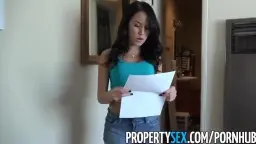 Landlord with turquoise top in the apartment hallway