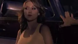 Asian lies back in red camper, tits exposed