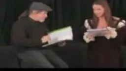 Performer with brown hair on green bedsheet